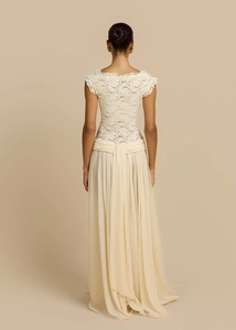 Detailed back view of chiffon maxi dress featuring white lace bodice and pleated cream skirt