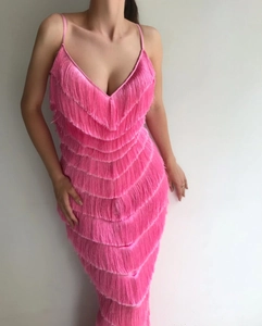 Detailed close-up of pink layered fringe and tiered tassels on the spaghetti strap dress