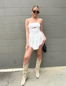 White strapless mini dress featuring a cutout chest and structured corset waist detail