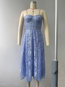 Detail shot of the intricate hollow floral lace embroidery on the light blue midi dress