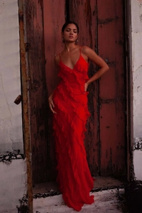 Close-up detail of tiered chiffon ruffles and fine straps on a red backless evening dress
