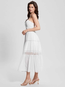 Detailed view of white layered maxi dress with geometric hollow lace and textured fabric