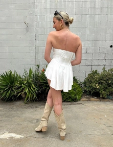 Detail view of white corset mini dress with boning structure and flared A-line skirt