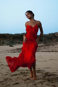 Detailed view of layered chiffon ruffles on a vibrant red backless beach maxi dress