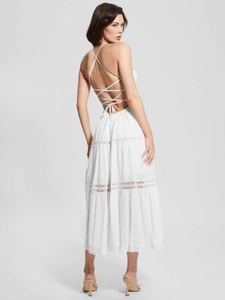 Detailed back view of a white lace backless dress with intricate crossover tie-up straps