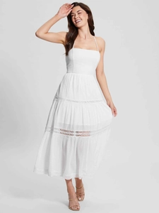 Detail of white tiered halter dress with delicate lace inserts and pleated fabric texture