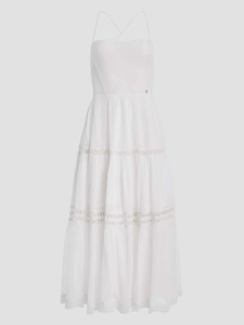 Detailed view of white tiered dress with crochet lace trim and metallic G buckle detail