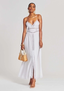 Close-up of white V-neck strap dress featuring intricate geometric lace and hollow out details