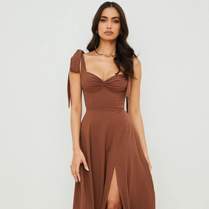 Detail of dark brown slip dress featuring shoulder bows and elegant pleated bust design