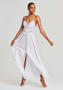 Detailed view of white lace maxi dress featuring high slit and intricate V-neck embroidery
