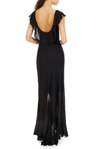 Detail view of the deep U-shaped backless design and ruffles on the black chiffon dress