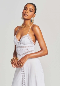 Close-up of white lace dress with intricate embroidery and hollow out details