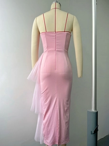 Detail of pink bodycon dress featuring red spaghetti straps and sheer mesh ruffles