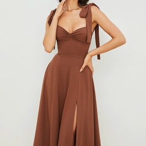 Detail of deep brown French dress featuring bow shoulder straps and heart neckline