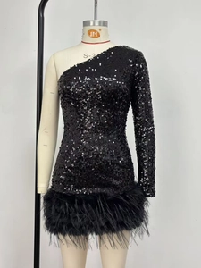 Détail rapproché des paillettes et des plumes noires sur une robe de soirée à une épaule