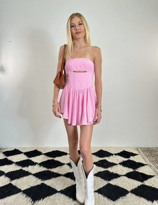 Detail of pink strapless mini dress featuring a cutout design and cinched corset waist