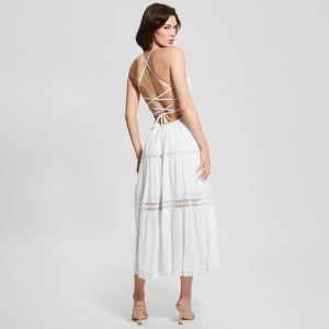 Elegant white backless midi dress with lace hollow out detail and multi-layered cake skirt