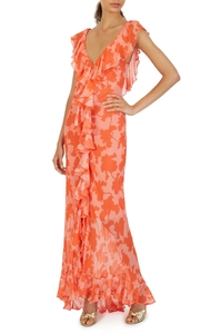Detail of coral orange floral V-neck dress featuring layered ruffles and high split hem