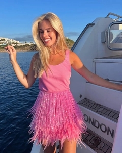 Close-up of pink party set with sequin top and feather fringe skirt on a yacht