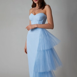 Detail of light blue strapless dress with layered mesh pleats and side slit detail