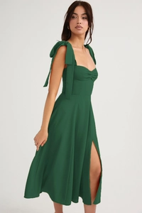 Detail view of dark green dress showing elegant chest pleats and shoulder bow straps
