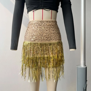 Detail of gold sequin mini skirt with long metallic fringe tassels for evening wear