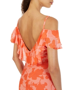 Detail of ruffle trim and backless design on a floral chiffon maxi dress