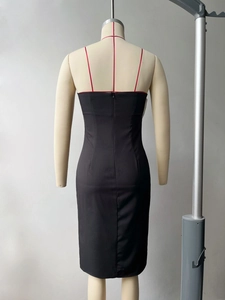 Detail of slim fit black midi dress featuring red spaghetti straps and back hidden zipper
