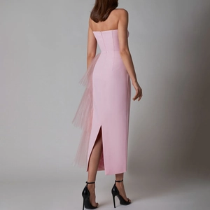 Rear view of pink slim fit evening gown featuring mesh ruffles and a back slit detail