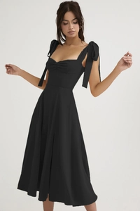 Detail of sweetheart neckline with pleated bodice and ribbon bow shoulder straps