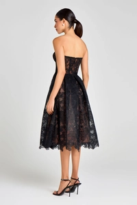 Detail view of black floral lace embroidery and sheer mesh layers on the cocktail dress