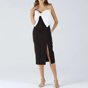 Elegant strapless black midi dress with large white bow and high side slit detail