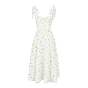 Detail of white floral sundress with yellow prints and bow shoulder straps