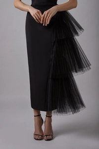 Detailed view of elegant black slim dress featuring layered mesh pleats and side slit