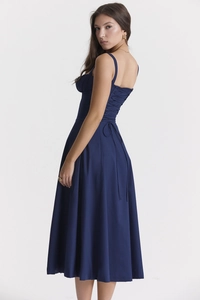 Detailed side-back view of navy blue midi dress featuring lace-up corset design and pleats