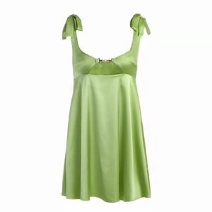Detail of light green satin dress with adjustable shoulder bow ties and metal buckle
