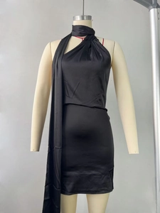 Close-up of black satin halter dress with draped neck and elegant long neck sash