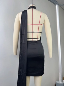 Detail of cross back straps and long satin ribbons on black backless cocktail dress