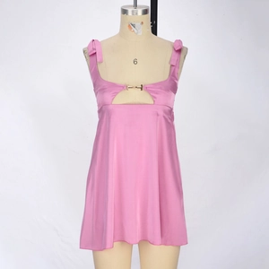 Detailed view of pink satin dress with bow shoulder straps and hollow-out metal buckle