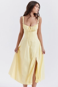 Detailed close-up of pale yellow midi dress showing drawstring pleats and high slit