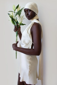 Elegant backless cream satin dress featuring a halter neck and matching headscarf