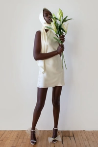 Detail of cream satin backless mini dress with elegant matching hooded headpiece