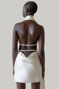 Detail of backless satin dress with adjustable metal buckles and champagne silk texture