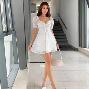Detailed view of the white puff sleeve mini dress with a sweetheart neckline and drawstring
