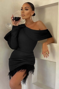 Detail of elegant black one-shoulder mini dress featuring delicate feather hem trim