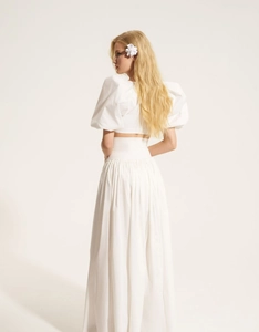 Detailed back view of white puff sleeve crop top and high waist maxi skirt set