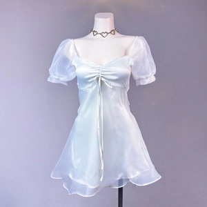 Detailed view of puffed organza sleeves and ruffled hem on light blue satin mini dress