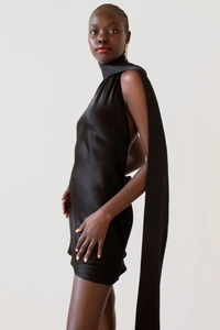 Detail of elegant black satin halter neck dress featuring long flowing ribbon ties