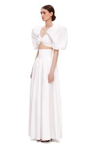 Detailed view of white two-piece set featuring puff sleeves and high-waist maxi skirt