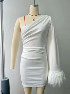 Detail of white one-shoulder dress showing elegant feather trim and ruched waist fabric